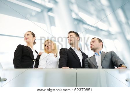 Group of businesspeople standing together in modern office