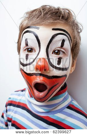 little cute boy with facepaint like clown, pantomimic expressions close up