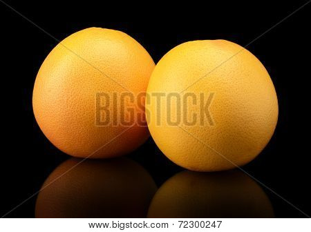 Studio Shot Of Two Grapefruits Isolated On Black Background