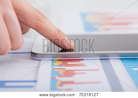 Businessman Analyzing Bargraph At Desk