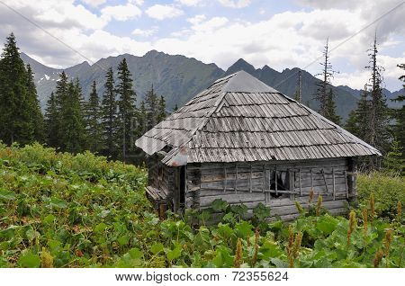Old wooden hunter's hut in mountains