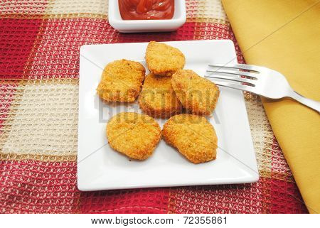 Chicken Or Fish Nuggets Served With A Condiment