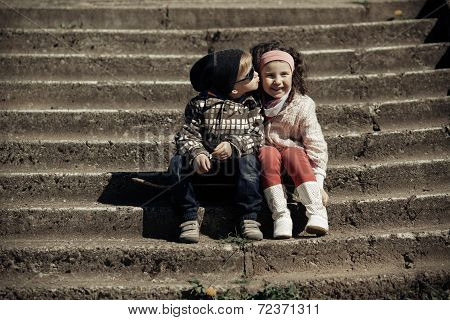 litle boy kissing girl
