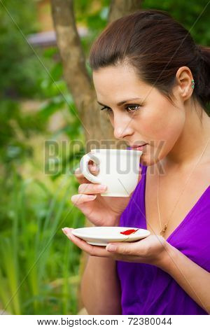 Beautiful Young Woman Drinking Coffee Outdoors