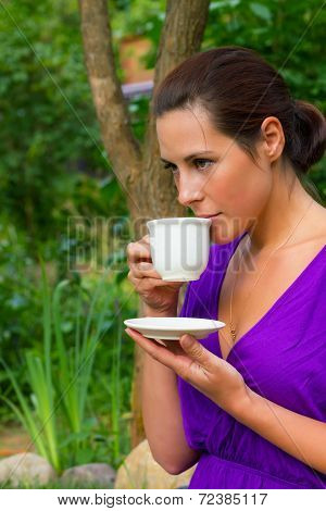 Beautiful Young Woman Drinking Coffee Outdoors