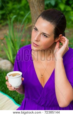 Beautiful Young Woman Drinking Coffee Outdoors