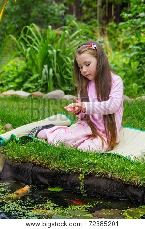Little Girl Feeding Fishes