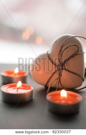 Ginger white heart shaped cookie as a present for Valentine's Day with burning candles