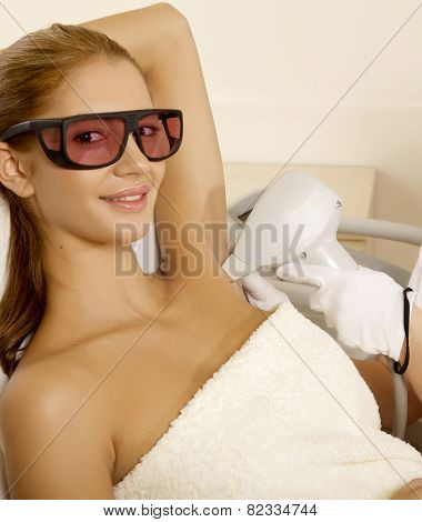 Portrait of young adult attractive and sensuality brunette pretty girl receiving laser therapy procedure. Woman getting laser face treatment in medical spa center skin rejuvenation concept