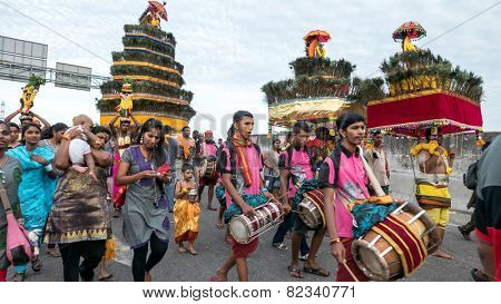 KUALA LUMPUR, MALAYSIA - FEBRUARY 3, 2015: Hindu devotees carry milk pots and kavadis walk in a procession to the Batu Caves temple on Thaipusam day, a day of thanksgiving and devotion.