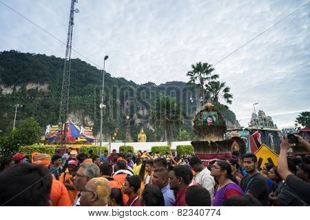 KUALA LUMPUR, MALAYSIA - FEBRUARY 3, 2015: Hindu devotees carry milk pots and kavadis walk in a procession to the Batu Caves temple on Thaipusam day, a day of thanksgiving and devotion.