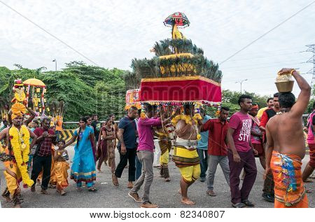 KUALA LUMPUR, MALAYSIA - FEBRUARY 3, 2015: Hindu devotees carry milk pots and kavadis walk in a procession to the Batu Caves temple on Thaipusam day, a day of thanksgiving and devotion.