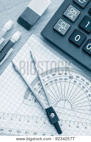 School supplies used in math , geometry or  science toned in blue