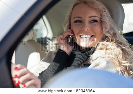 Smiling Woman Driving While Phoning