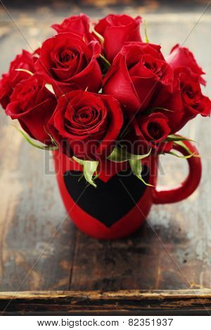 Valentine composition with roses on wooden background