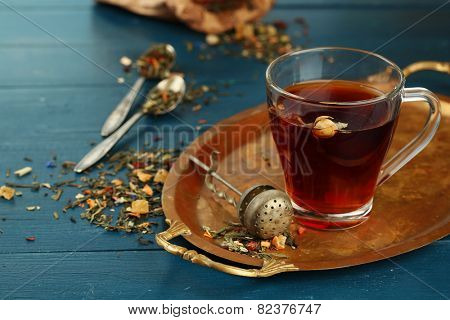 Beautiful vintage composition with herbal tea, on wooden table