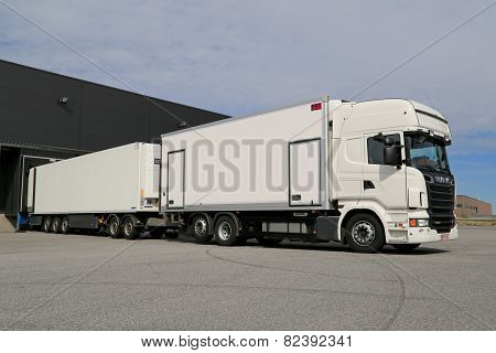 White Scania R560 Full Trailer Truck Unloading At A Warehouse