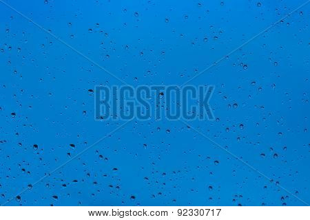 Raindrops on the window with blue sky