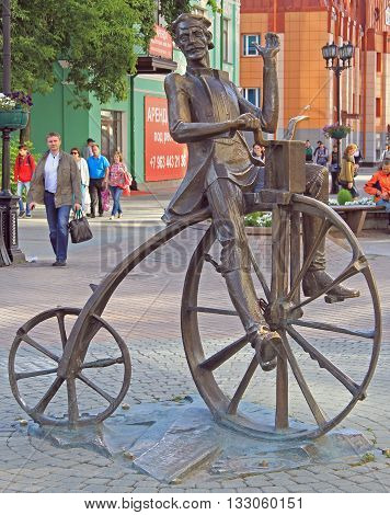 Yekaterinburg Russia - July 20 2015: The bronze sculpture of the inventor of the bike Artamonov set on the street Weiner in Yekaterinburg