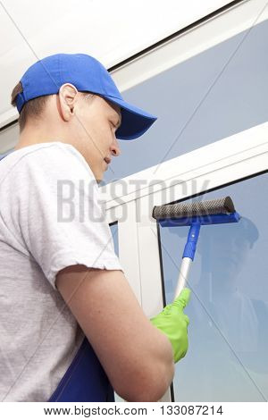 Professional cleaning, man washes window
