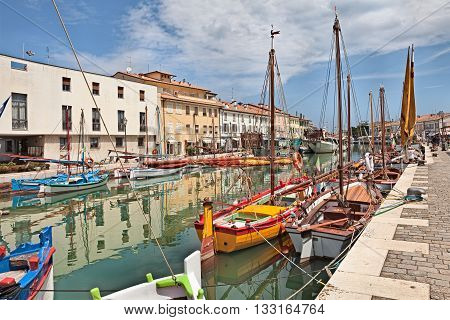 CESENATICO (FC) ITALY - JUNE 4: the port canal designed by Leonardo da Vinci in the old town with colored wooden sailboats on January 12 2013 in Cesenatico Emilia Romagna Italy