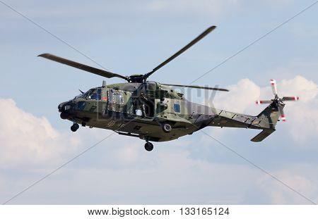BERLIN / GERMANY - JUNE 3 2016: tactical troop helicopter NH90 from nato helicopter industries flies in berlin germany on june 3 2016.