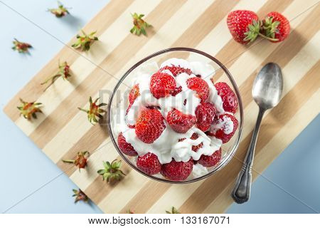 Fresh strawberries and cream served on the table