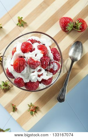 Fresh strawberries and cream served on the table