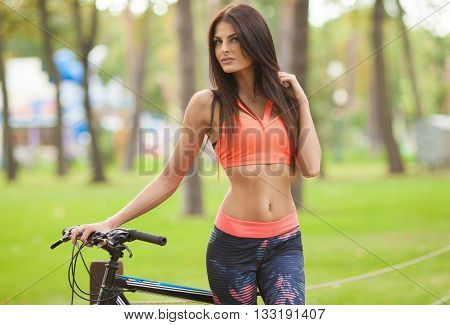sexy cute sport girl on sports bike. Blurred background.