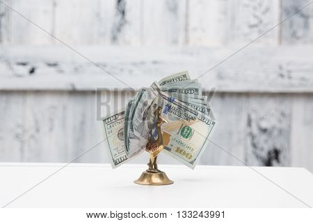 Money bird on table. American dollars banknotes isolated over white background in studio. Much money of dollars.