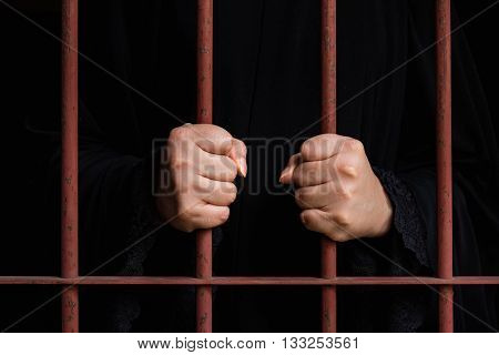 Close up hand of muslim woman holding iron bar in jal.