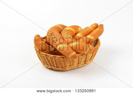 scuttle of fresh bread rolls on white background