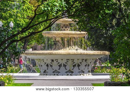 Moscow Russia - August 18 2013: Little fountain in the Gorkiy Park and several passers