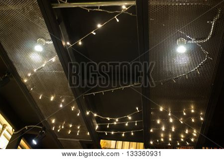 Vintage hanging light bulb on room ceiling stock photo