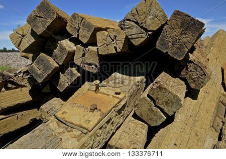 A  pile of stacked railroad ties have been removed from the track bed.