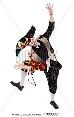 Smiling harlequin wearing a mask, isolated on white background in full length.