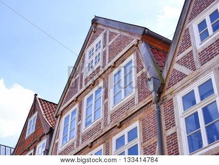 Old town houses and blue sky. Half-timbered houses of cobblestone, North Germany. Middle age or dark age building exterior.