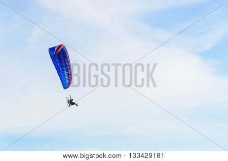 man ride Paramotor flying in the sky