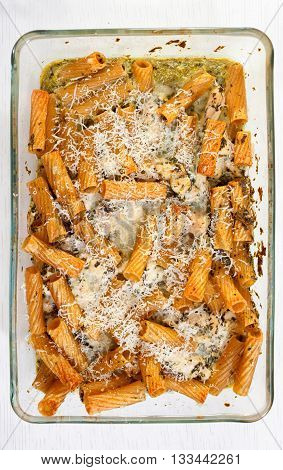 Baked Penne pasta with parmesan cheese in caserole. Shot from above. Full length.
