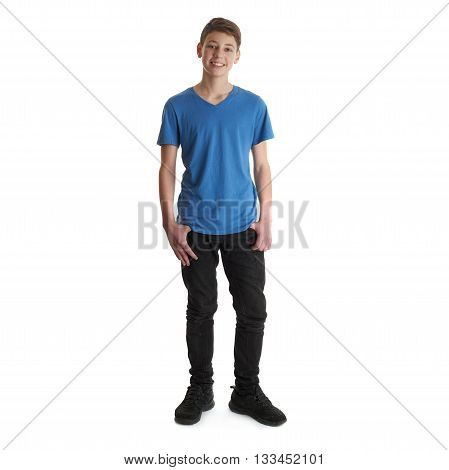 Cute teenager boy in blue T-shirt standing over white isolated background full body