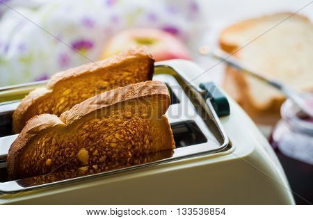 Toaster and two hot toasts ready to serve for the breakfast
