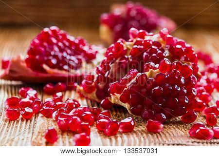Pomegranates on old wooden table, selective focus