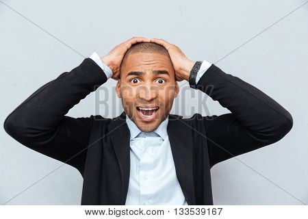 Close-up portrait of unhappy upset businessman guy isolated on gray background