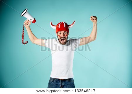 The football fan with mouthpiece over blue background