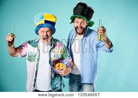 The two football fans over blue background