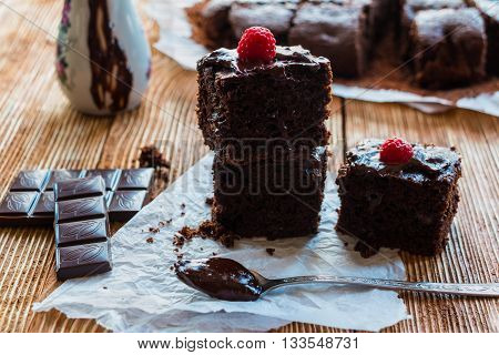 Homemade chocolate brownies with raspberry on the wooden background