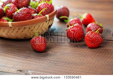Very Beautiful Background With Fresh Strawberries In A Wicker Round Osier Basket On Old Brown Wooden