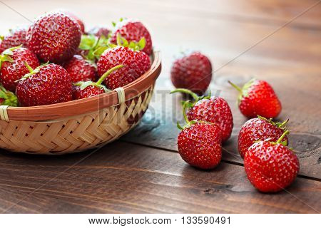 Very Beautiful Background With Fresh Strawberries In A Wicker Round Osier Basket On Old Brown Wooden