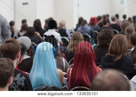 Visitors Sitting And Watching Streaming On Projection Screen