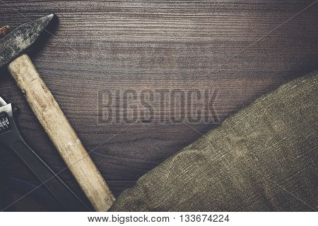different rusty construction instruments on the wooden background